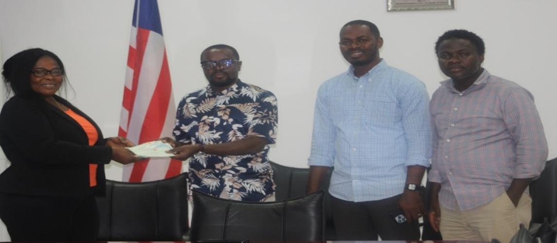 Deputy Commerce Min./Adm. Wilfred Bangura presenting the checks 